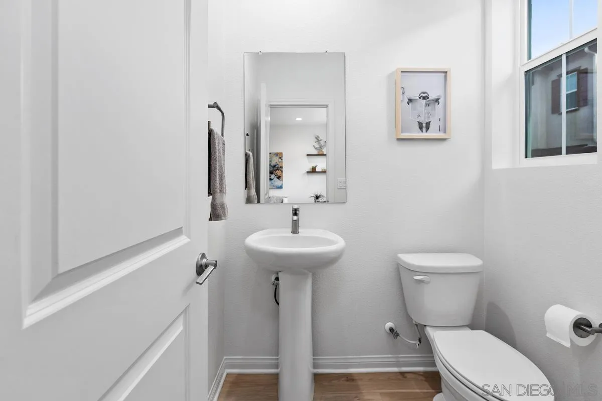 10149 Graphite Street Spring Valley, CA 91977 - Photo 14 of 35 a bathroom with a toilet a sink and mirror