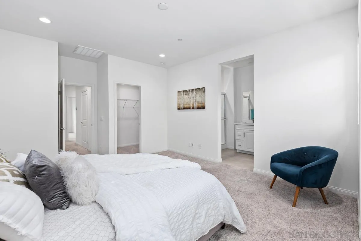 10149 Graphite Street Spring Valley, CA 91977 - Photo 16 of 35 a bedroom with a bed a chair and potted plant