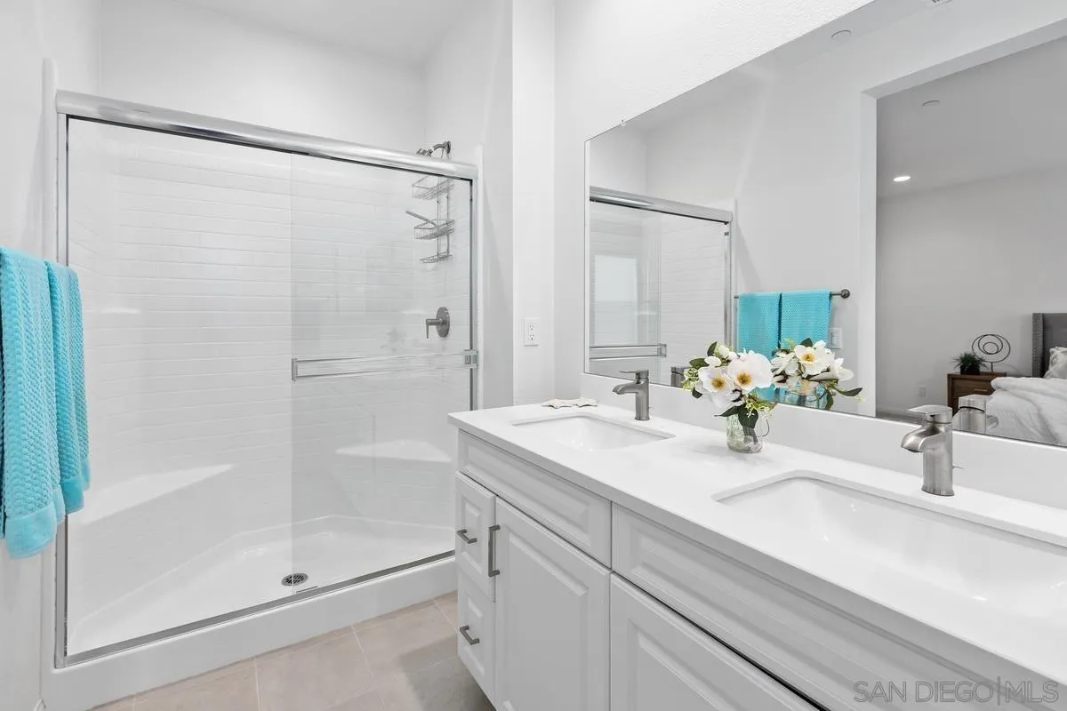 10149 Graphite Street Spring Valley, CA 91977 - Photo 17 of 35 a bathroom with a shower sink vanity and mirror