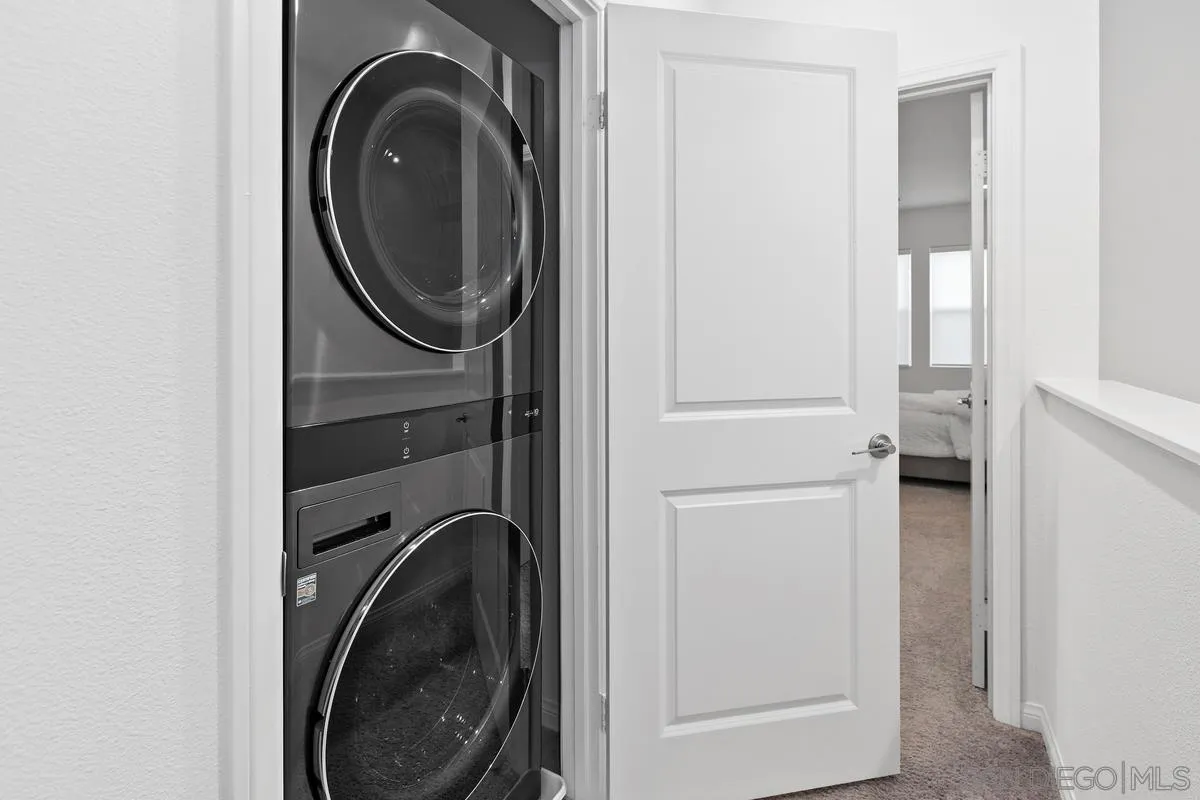 10149 Graphite Street Spring Valley, CA 91977 - Photo 19 of 35 a view of a hallway with washer and dryer