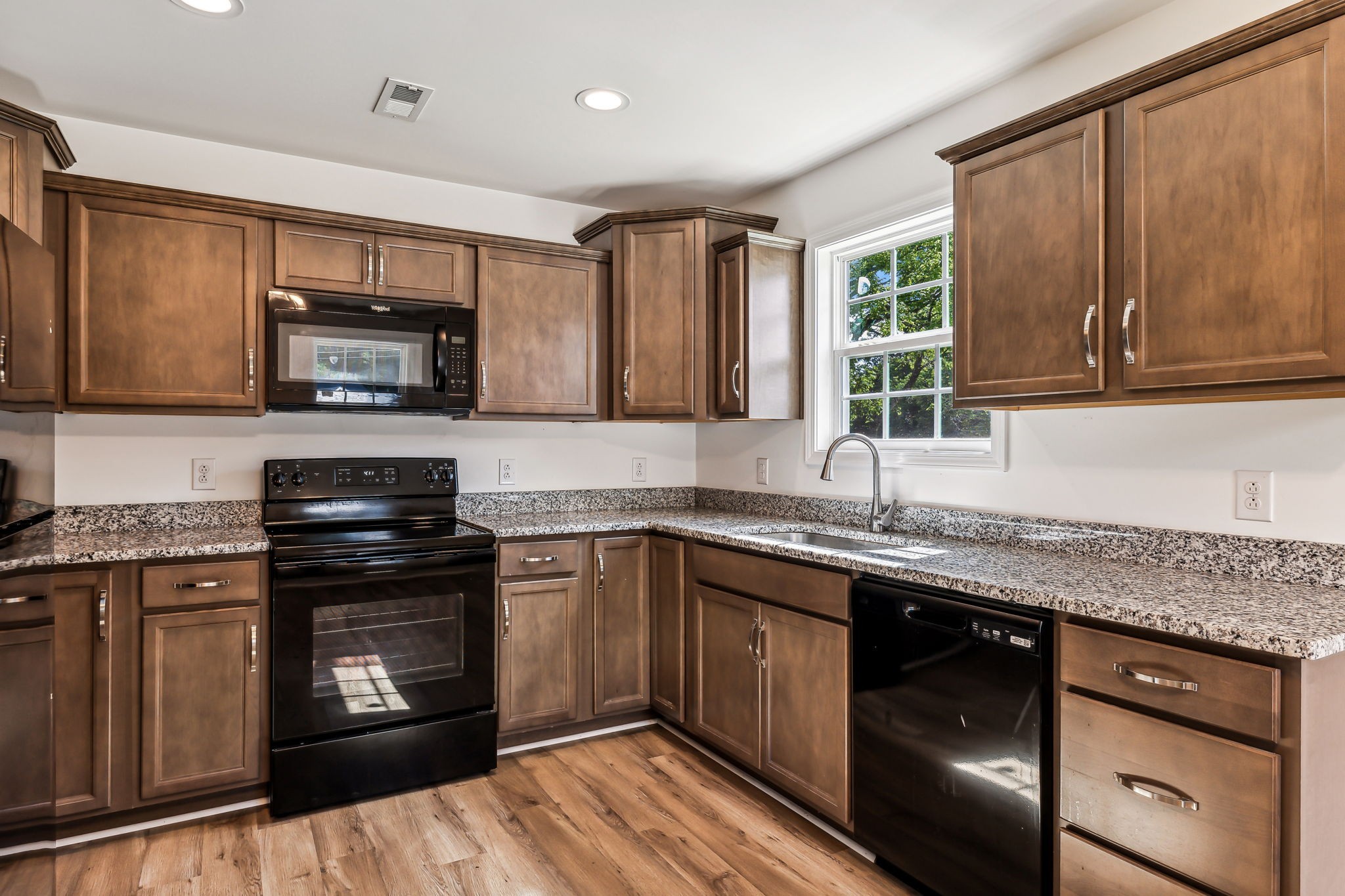 1816 Cunningham Ridge Clarksville, TN 37040 - Photo 12 of 32 a kitchen with stainless steel appliances granite countertop wooden cabinets granite counter tops and a window