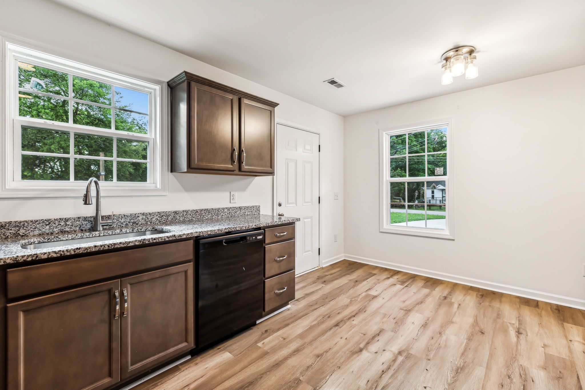 1816 Cunningham Ridge Clarksville, TN 37040 - Photo 13 of 32 a kitchen with granite countertop wooden cabinets a sink and a window