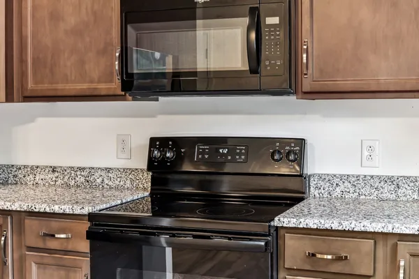 a stove top oven sitting inside of a kitchen