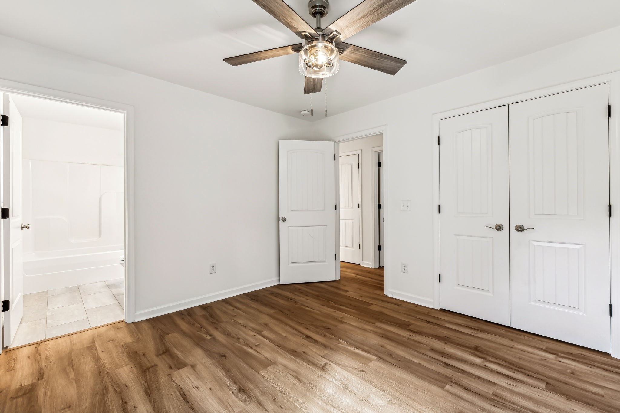 1816 Cunningham Ridge Clarksville, TN 37040 - Photo 17 of 32 a view of a livingroom with wooden floor and a ceiling fan