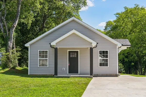a front view of house with yard and green space