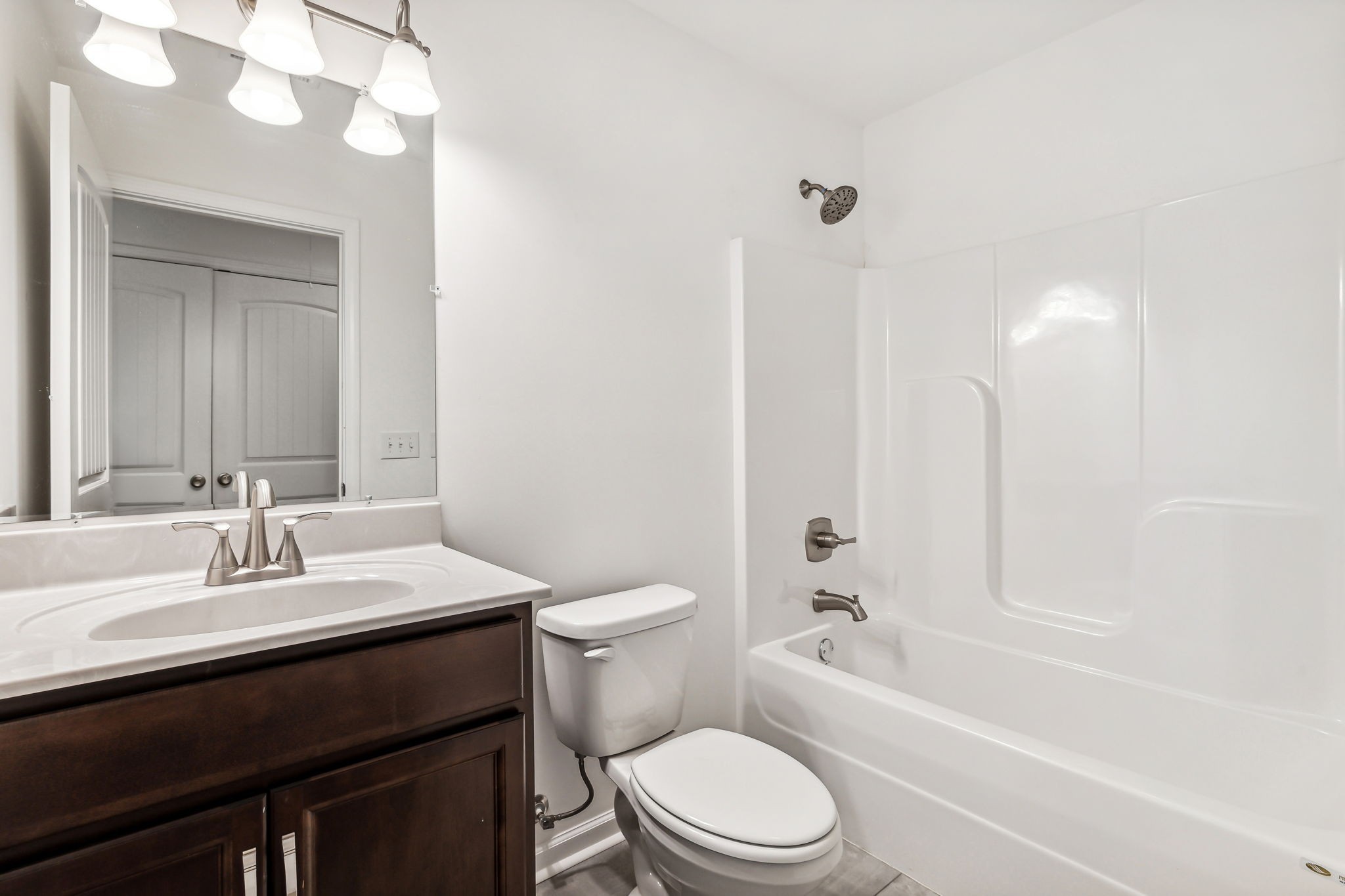 1816 Cunningham Ridge Clarksville, TN 37040 - Photo 23 of 32 a bathroom with a sink a toilet a mirror and shower
