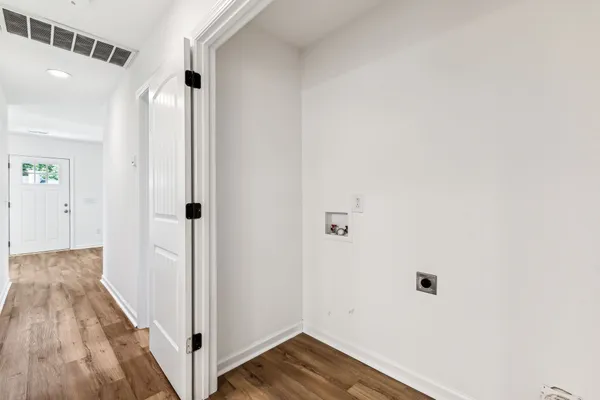 a view of a hallway with wooden floor