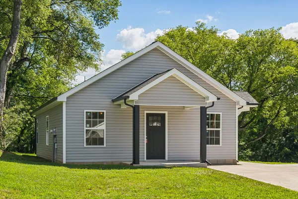 a view of house with backyard and garden