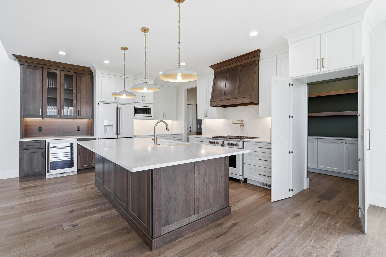 6928 Wilderness Pointe Bettendorf, IA 52722 - Photo 22 of 48 a kitchen with stainless steel appliances granite countertop a sink a stove and a wooden floor