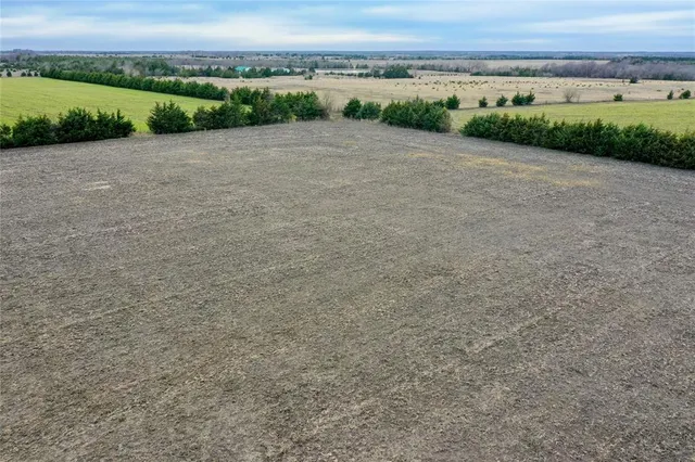 a view of a green field with an outdoor space