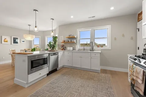 a kitchen with a stove a sink and a refrigerator