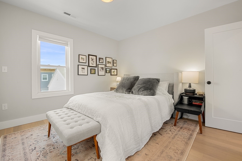 51 Cutler Street, Unit 3 Winthrop, MA 02152 - Photo 15 of 28 a bedroom with a bed and wooden floor