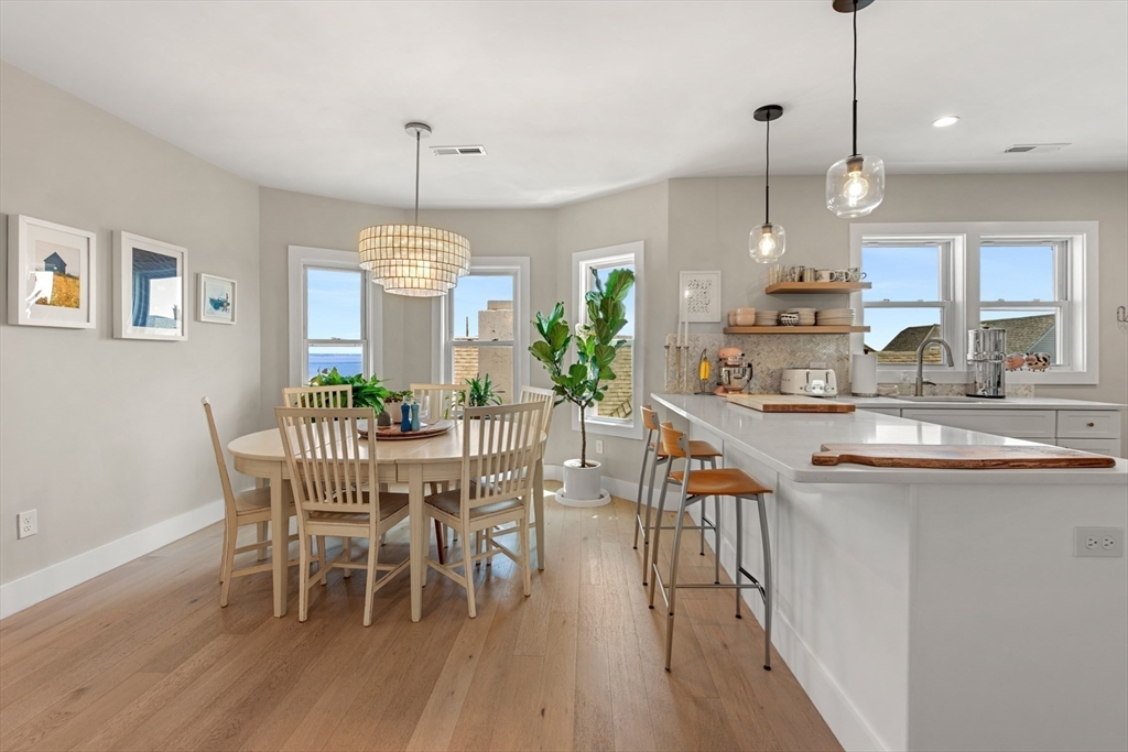 51 Cutler Street, Unit 3 Winthrop, MA 02152 - Photo 8 of 28 a dining room with furniture a chandelier and wooden floor