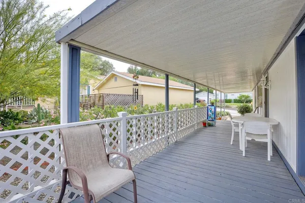 a view of a chairs and table in patio with wooden floor