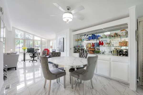 a dining area with furniture and a large window