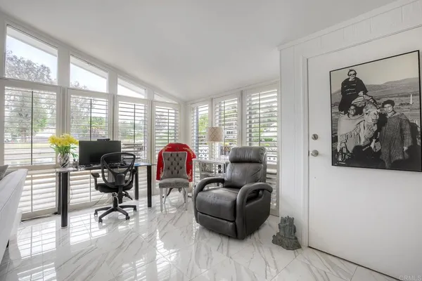 a view of a livingroom with workspace and a window