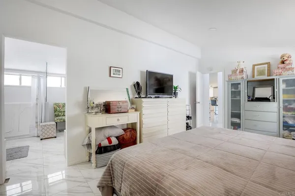 a bedroom with a bed and a flat screen tv