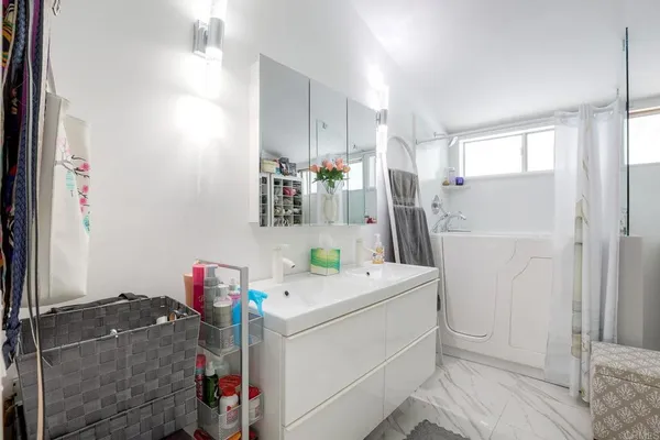 a bathroom with a sink toilet and shower