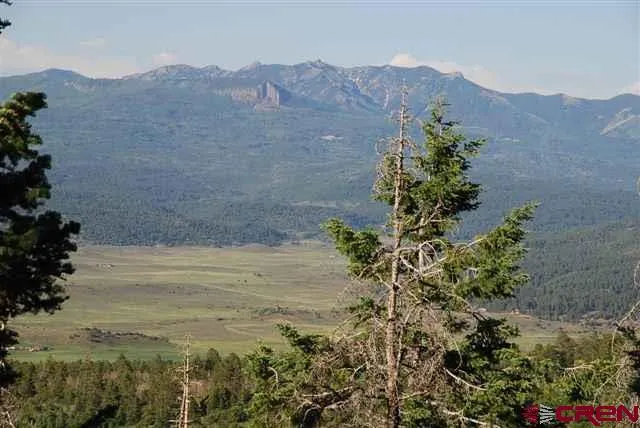 a view of mountain with sunset in the background