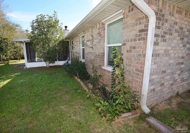 a view of a brick house with a yard