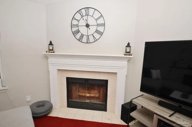 a living room with a fireplace and a flat screen tv