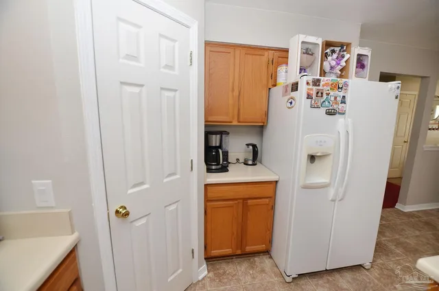a room with a refrigerator and a sink