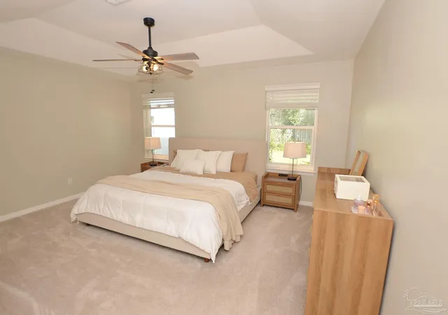 a bedroom with a large bed and a chandelier