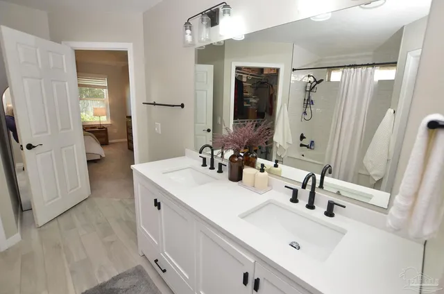 a bathroom with a sink vanity and mirror
