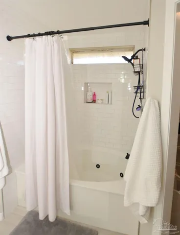 a bathroom with a shower and a bath tub