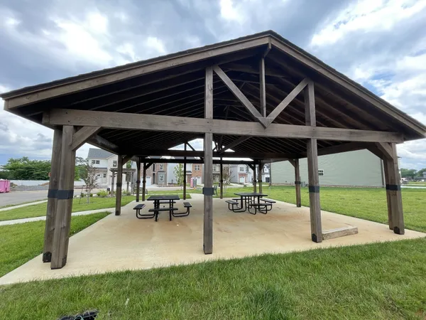 a view of a patio with table and chairs under an umbrella