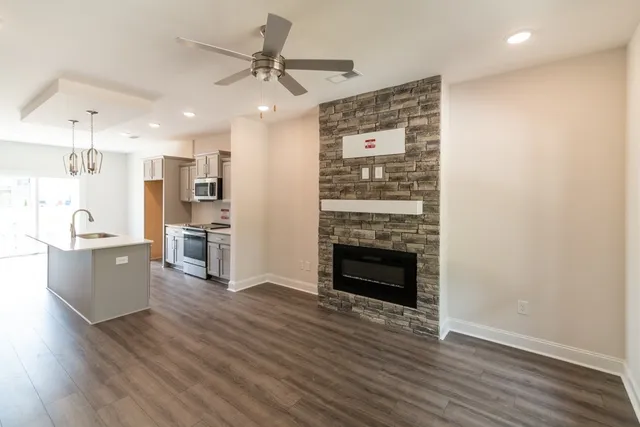 a view of a kitchen with wooden floor and a ceiling fan