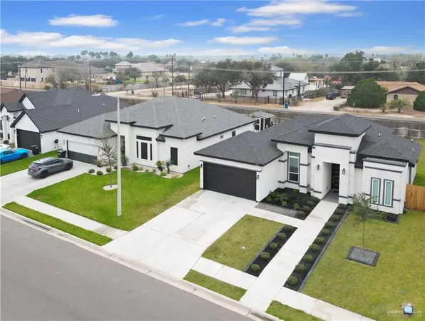 an aerial view of a house with a garden and trees