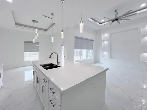 a kitchen that has a sink a stove and a table in it