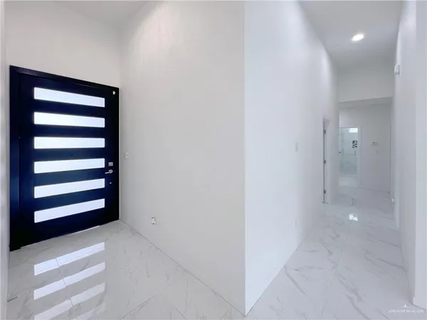 a view of a bedroom with wooden floor and cabinet