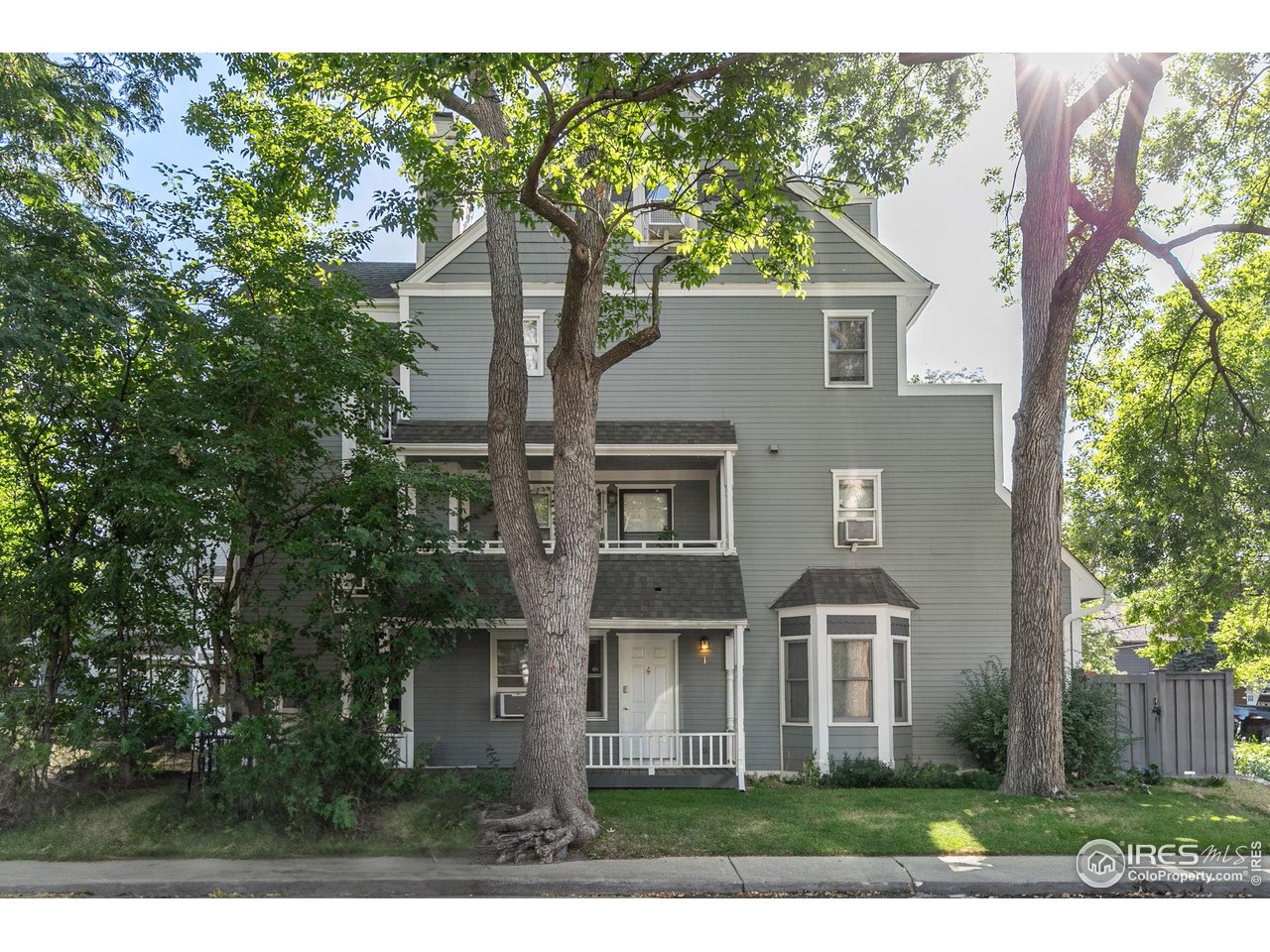 1430 18th Street, Unit 1 Boulder, CO 80302 - Photo 14 of 29 a front view of a house with a yard