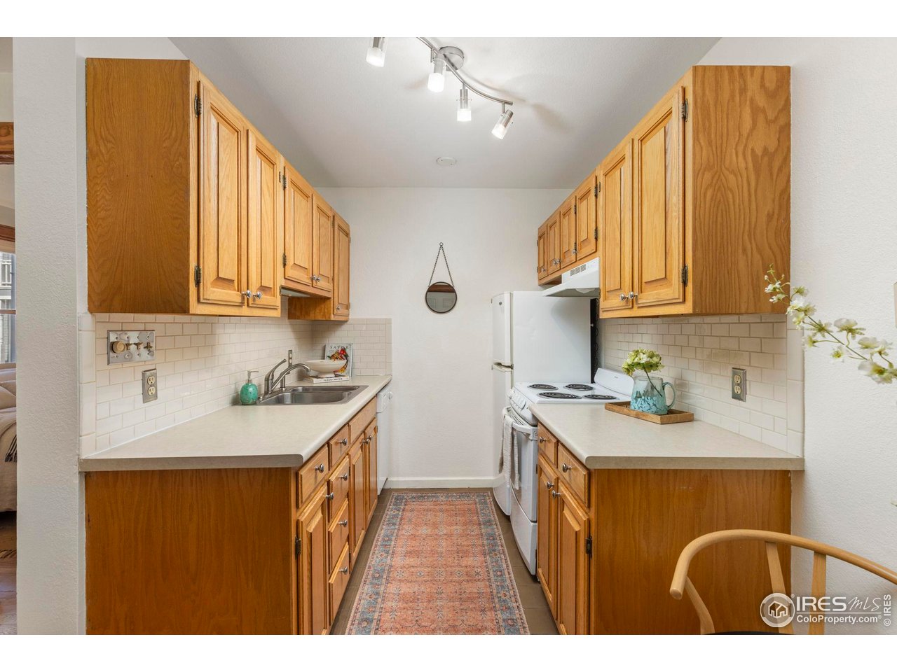 1430 18th Street, Unit 1 Boulder, CO 80302 - Photo 8 of 29 a kitchen with a sink a stove and cabinets