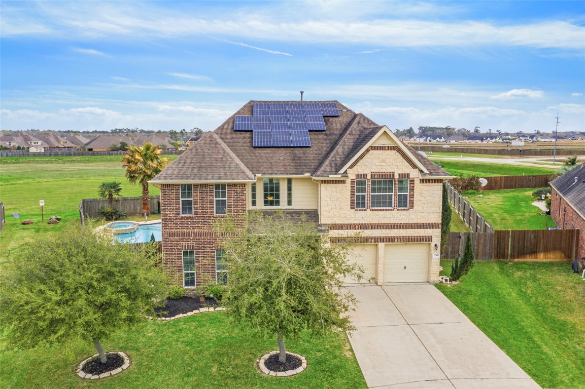 12402 Garnet Road Mont Belvieu, TX 77535 - Photo 1 of 49 a house view with a garden space