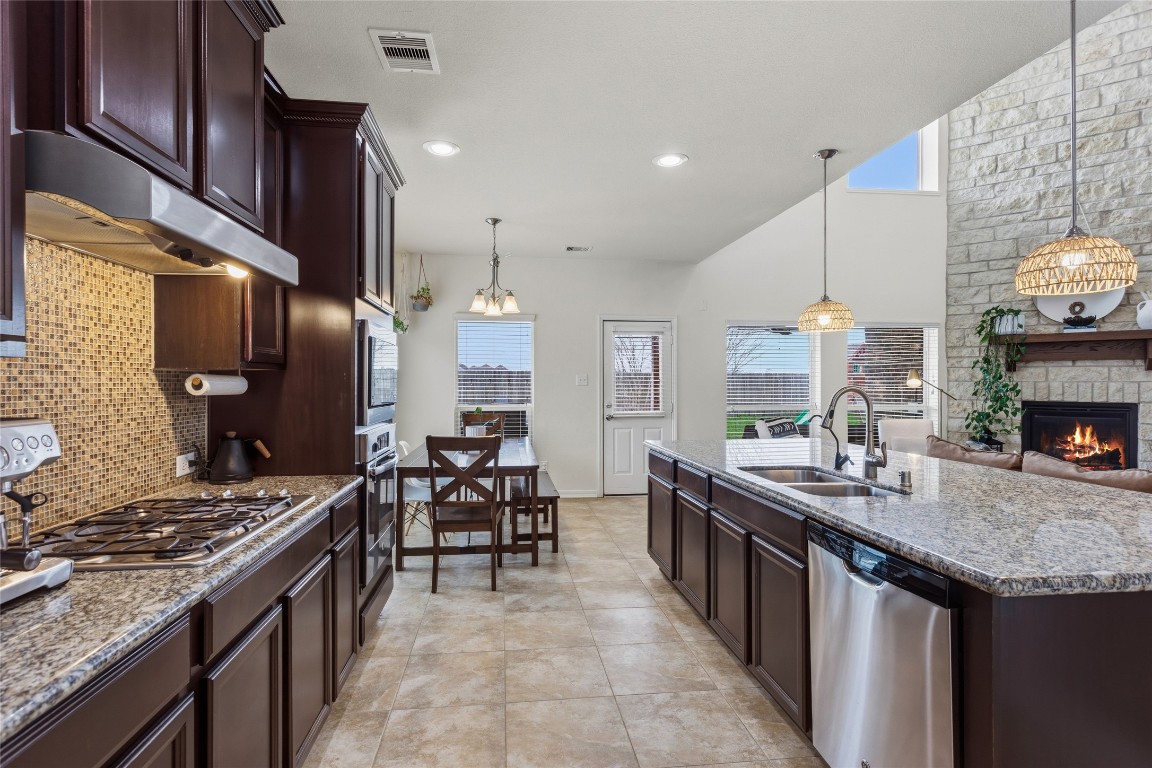 12402 Garnet Road Mont Belvieu, TX 77535 - Photo 13 of 49 a kitchen with sink stove and cabinets