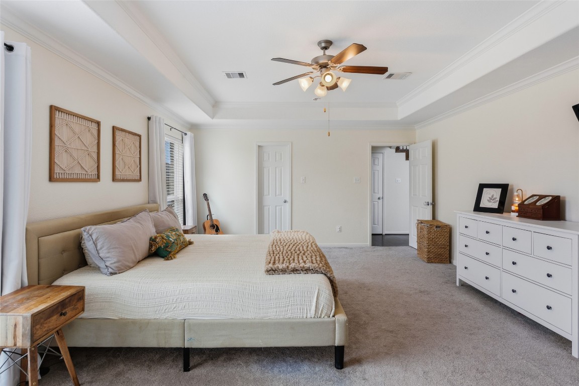 12402 Garnet Road Mont Belvieu, TX 77535 - Photo 17 of 49 a bedroom with a bed and a chandelier