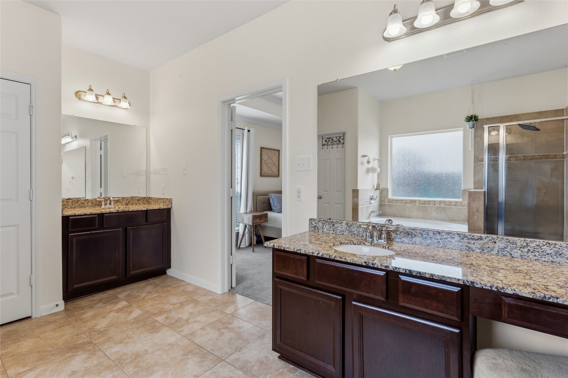 12402 Garnet Road Mont Belvieu, TX 77535 - Photo 21 of 49 a bathroom with a granite countertop sink and a mirror