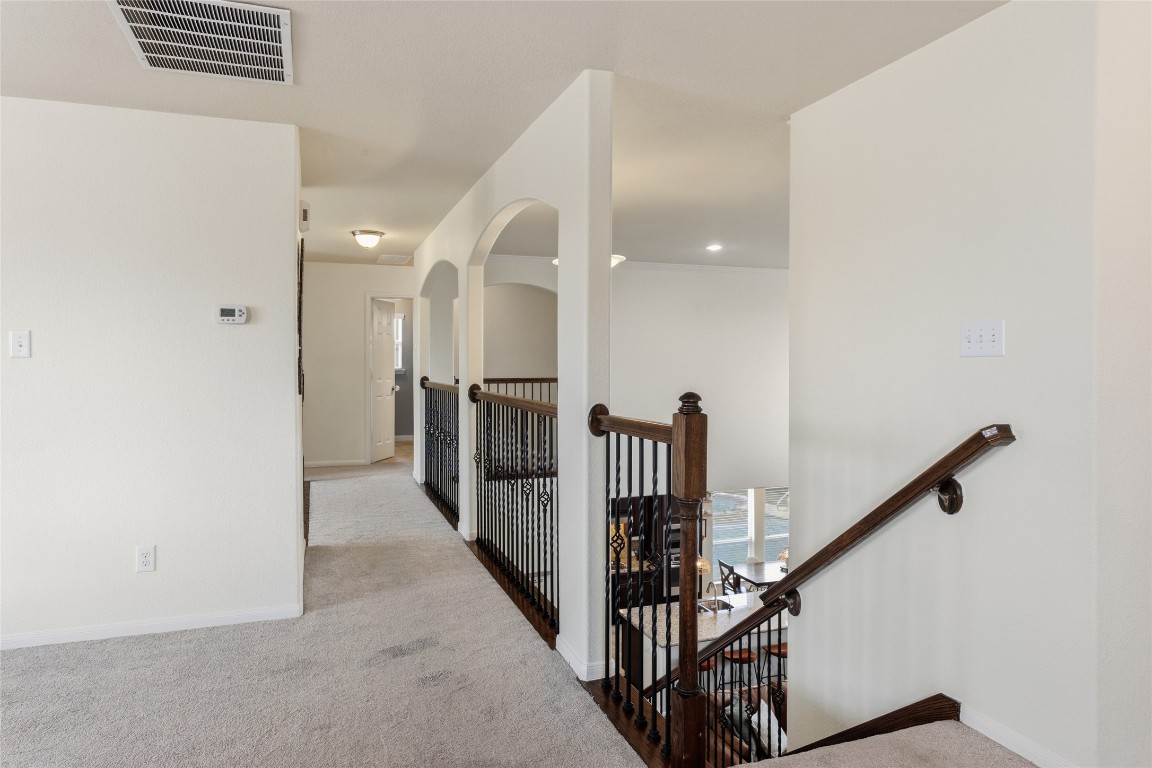 12402 Garnet Road Mont Belvieu, TX 77535 - Photo 27 of 49 a view of a hallway with a white door and stairs