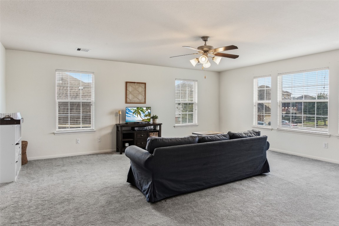 12402 Garnet Road Mont Belvieu, TX 77535 - Photo 28 of 49 a living room with furniture and windows