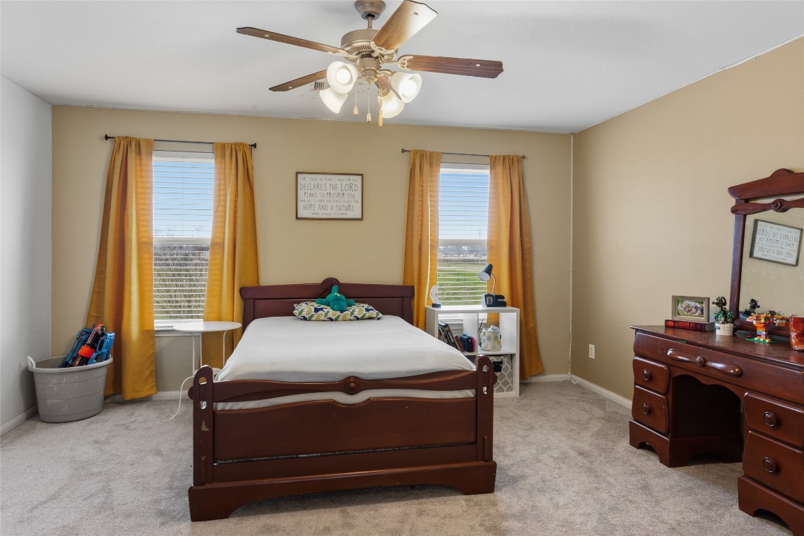 12402 Garnet Road Mont Belvieu, TX 77535 - Photo 30 of 49 a room with a bed and a potted plant