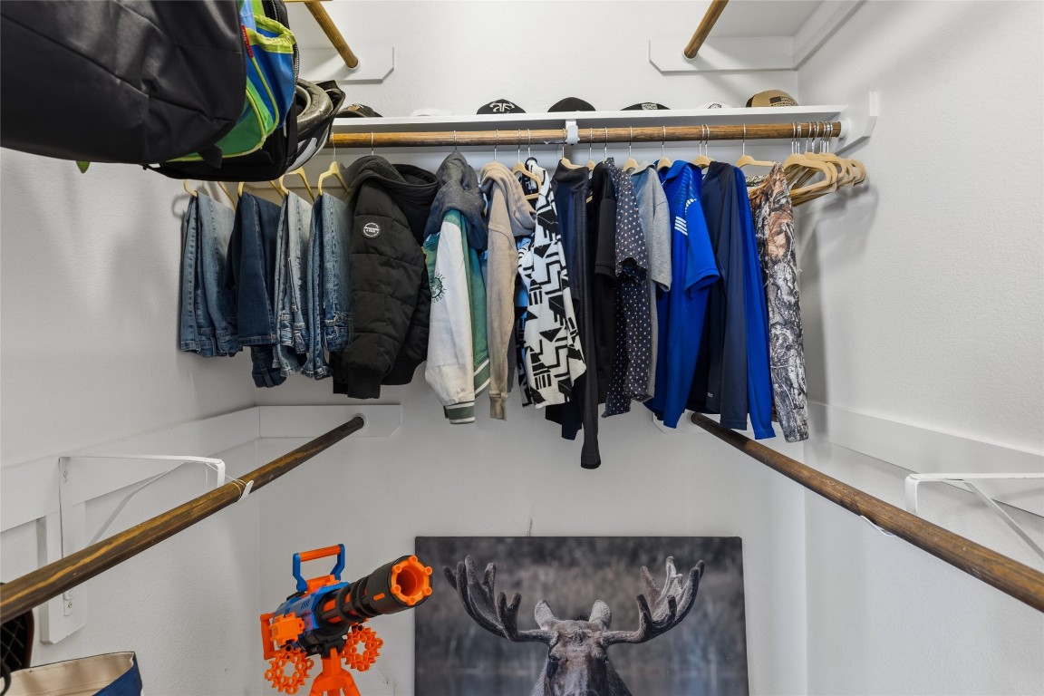 12402 Garnet Road Mont Belvieu, TX 77535 - Photo 31 of 49 a view of walk in closet with clothes and shoes