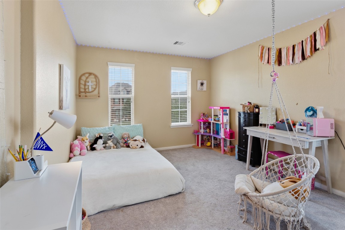 12402 Garnet Road Mont Belvieu, TX 77535 - Photo 34 of 49 a bedroom with a bed and a table in it