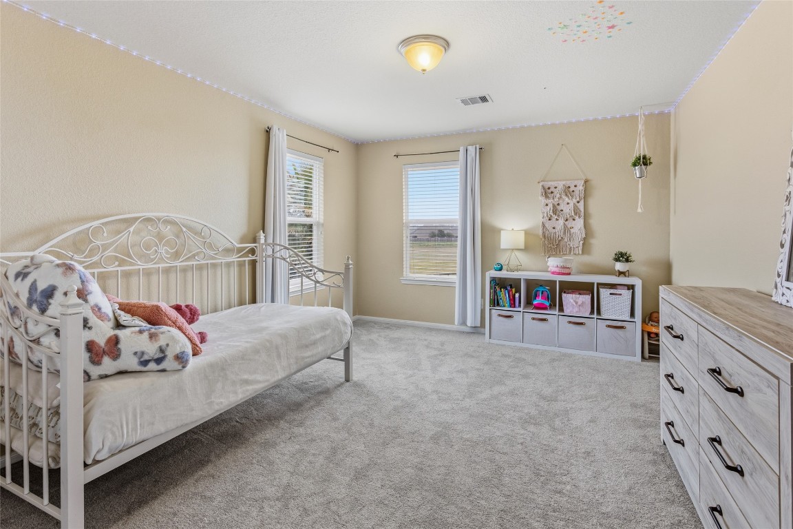 12402 Garnet Road Mont Belvieu, TX 77535 - Photo 35 of 49 a living room with furniture and a table