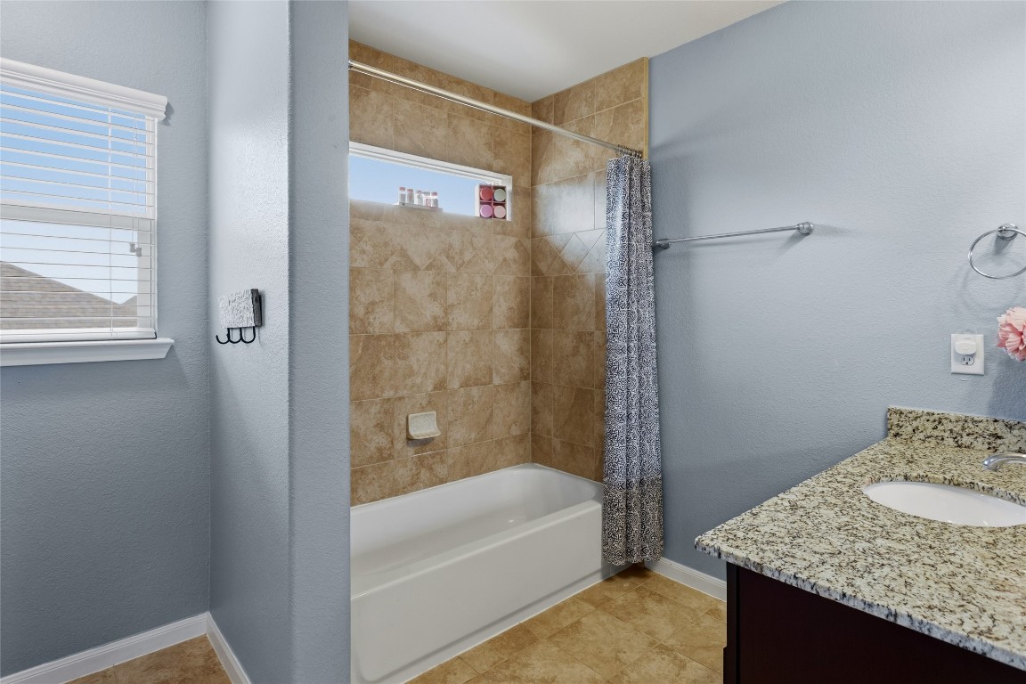 12402 Garnet Road Mont Belvieu, TX 77535 - Photo 36 of 49 a bathroom with a granite countertop sink and a bathtub