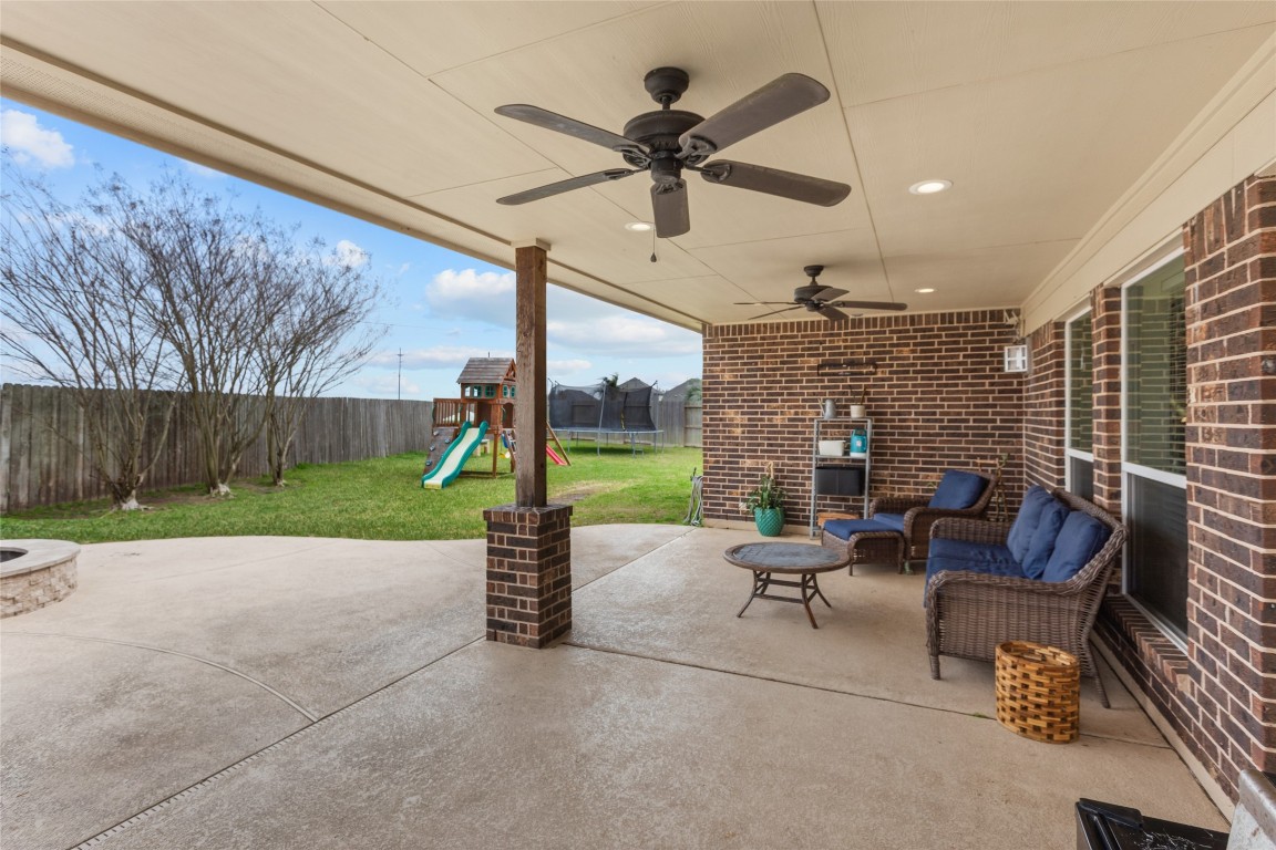 12402 Garnet Road Mont Belvieu, TX 77535 - Photo 38 of 49 a view of a patio with a table chairs and a backyard