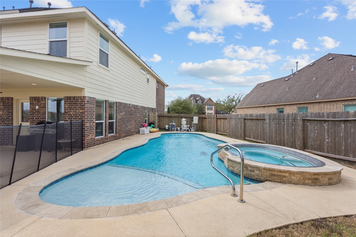 12402 Garnet Road Mont Belvieu, TX 77535 - Photo 40 of 49 a view of backyard with swimming pool and seating