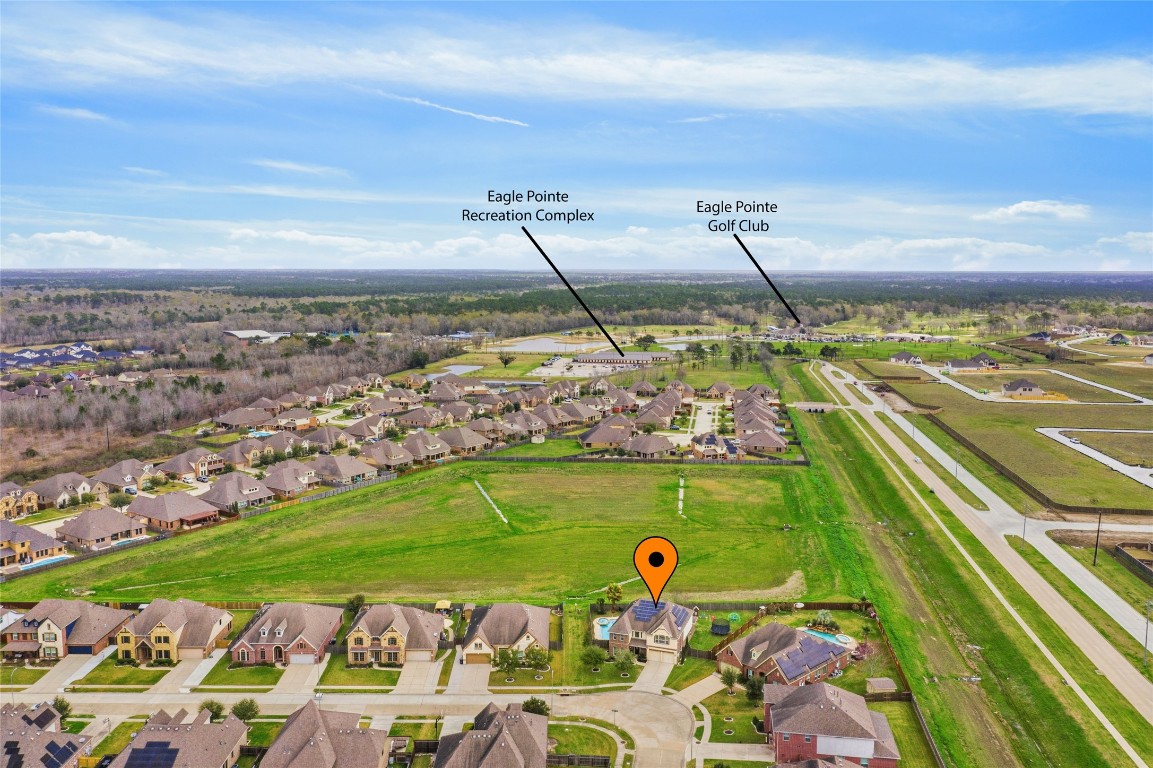 12402 Garnet Road Mont Belvieu, TX 77535 - Photo 4 of 49 a view of a swimming pool with a lake view